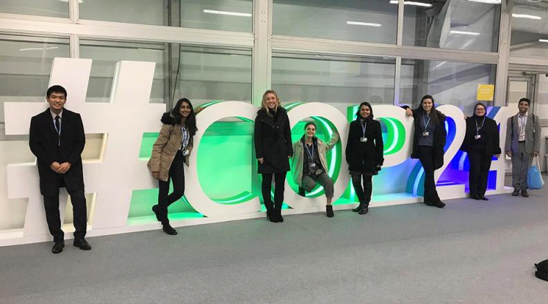 #COP24 sign with members of the Cornell Delegation.