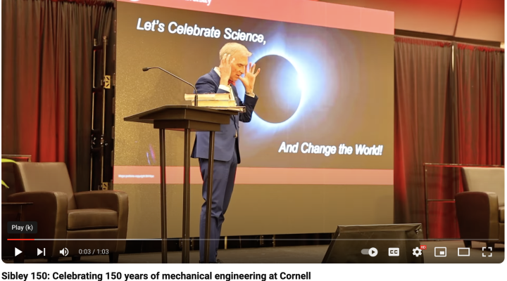 Bill Nye standing on a stage, gesturing with his hands near his head. The image is a screenshot from a YouTube video condensing highlights of the Sibley 150 celebration that took place on the Cornell campus on April 25, 2024.