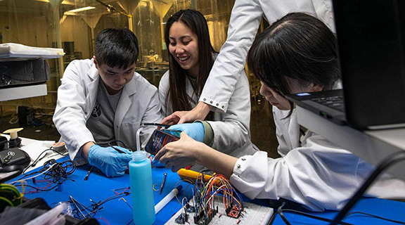 Students work on small satellite project together