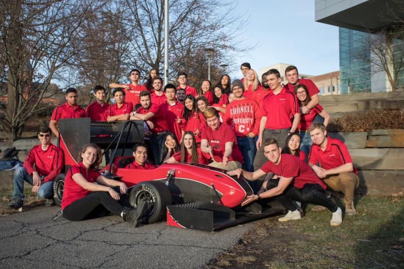 Members of Cornell Racing pose with their race car