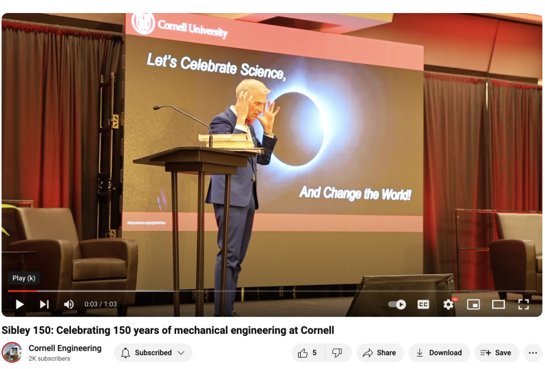 Bill Nye standing on a stage, gesturing with his hands near his head. The image is a screenshot from a YouTube video condensing highlights of the Sibley 150 celebration that took place on the Cornell campus on April 25, 2024.