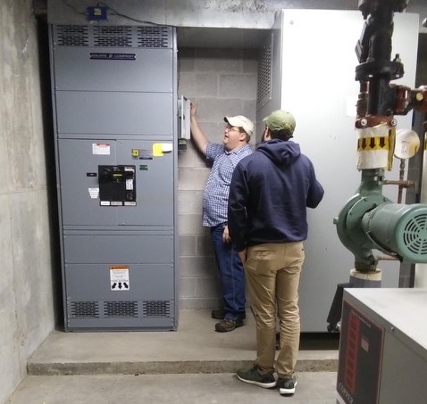 two people installing equipment