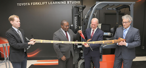 Four men participate in a ribbon cutting ceremony at Cornell's Toyota Forklift Learning Studio